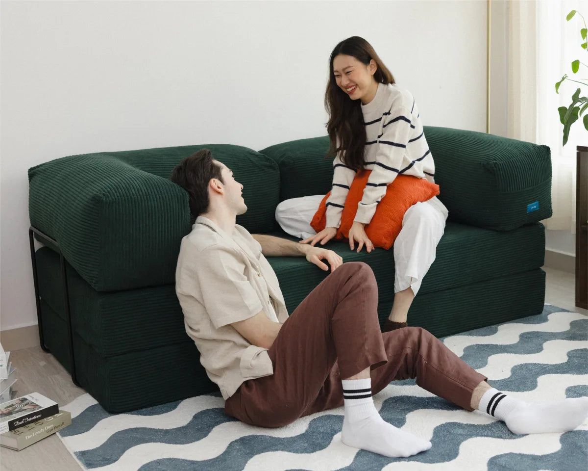 A couple relaxing on the modular Joey Sofa